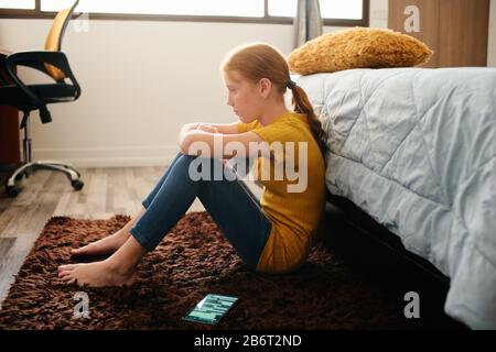 Preteen Bullied Girl Feeling Lonely And Sad At Home Stock Photo