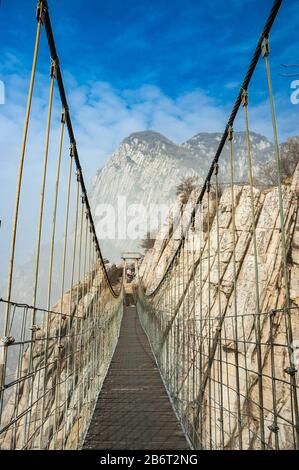 Rope bridge on the Shaoshi Shan mountain walk at Shaolin Temple. Shaolin Temple in famous for kungfu and is near Dengfeng in Henan Province, China. Stock Photo