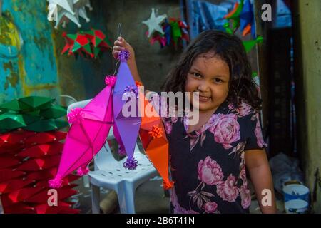 Filipino girl holding a lantern in a Christmas market in Las Pinas city , Manila the Philippines Stock Photo