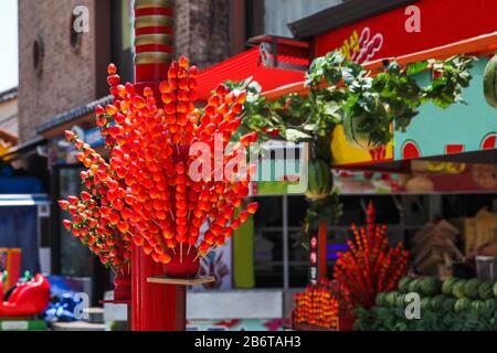 Traditional Chinese snack candied strawberries fruit on a stick , TangHuLu, displayed on a street Stock Photo