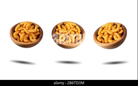 Three wooden bowls with puffed corn peanuts snacks. Isolated on white background with shadow. Banner. Photos taken from different angles. Stock Photo