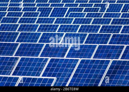 Dusty solar panels surface requires maintenance and cleaning. Solar power electric generating system and facility. Stock Photo