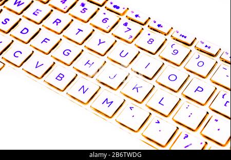 Close up view of a modern laptop computer keyboard keys. Soft lightning in blue tones. Pc computer keyboard close up Stock Photo
