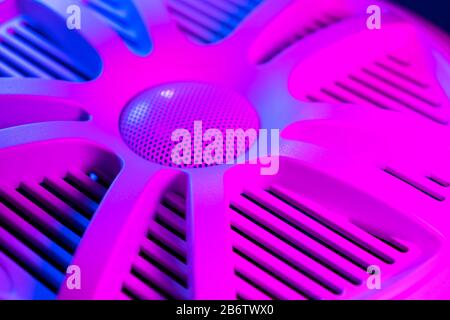 Colorful lights of car stereo and car speakers background.  Car music audio speaker in blue and pink tones. Modern car audio system close up Stock Photo