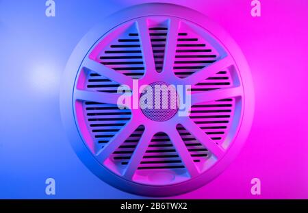 Colorful lights of car stereo and car speakers background.  Car music audio speaker in blue and pink tones. Modern car audio system close up Stock Photo