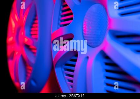 Colorful lights of car stereo and car speakers background.  Car music audio speaker in blue and pink tones. Modern car audio system close up Stock Photo