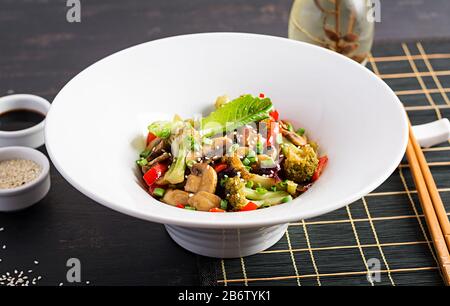 Stir fry vegetables with mushrooms, paprika, red onions and broccoli. Healthy food. Asian cuisine. Stock Photo