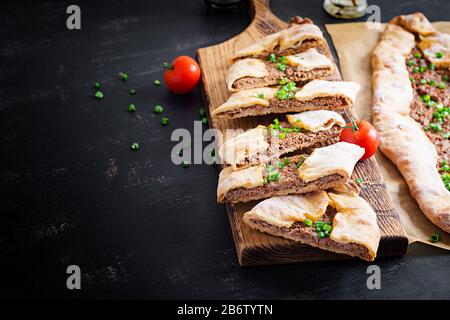 Turkish pide with minced meat, Kiymali Pide. Traditional Turkish cuisine. Turkish pizza Pita with meat. Stock Photo