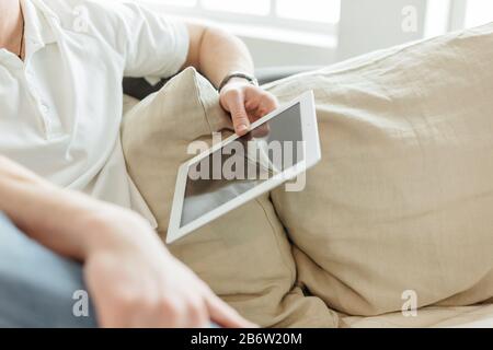 young man reading mail on a digital tablet Stock Photo