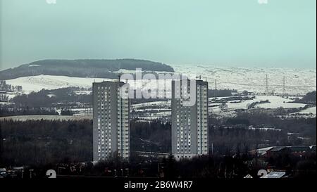 Glasgow, Scotland, UK, 12th March, 2020: UK Weather: Overnight snow was highlighted on the Kilpatrick hills in the north west of the city over the suburb of Drumchapel and its twin towers. Copywrite Gerard Ferry/ Alamy Live News Stock Photo