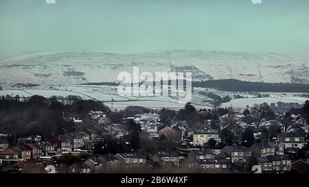 Glasgow, Scotland, UK, 12th March, 2020: UK Weather: Overnight snow was highlighted on the Campsie Fell  hills in the north west of the city over the suburb of Bearsden. Copywrite Gerard Ferry/ Alamy Live News Stock Photo