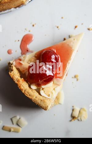Coconut custard pie with strawberry jam on marble background Stock Photo