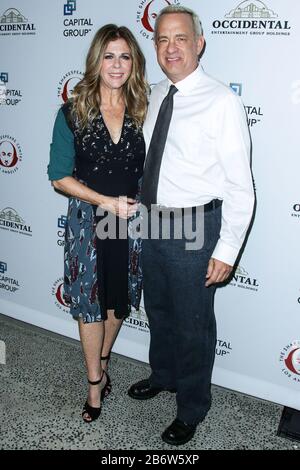 (FILE) Tom Hanks and Rita Wilson Test Positive for Coronavirus COVID-19. Tom Hanks and Rita Wilson have announced on Wednesday, March 11, 2020 that they have tested positive for COVID-19 (Coronavirus), the first celebrities to go public with a diagnosis. SANTA MONICA, LOS ANGELES, CALIFORNIA, USA - DECEMBER 08: Actor Tom Hanks and wife/actress Rita Wilson arrive at 25th Annual Simply Shakespeare Benefit Reading of 'Twelfth Night' held at The Broad Stage on December 8, 2015 in Santa Monica, Los Angeles, California, United States. (Photo by Xavier Collin/Image Press Agency) Stock Photo