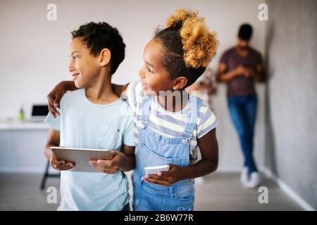 Happy children havig fun and using technology devices Stock Photo