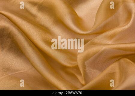 Shiny cloth background with beige vial textile Stock Photo