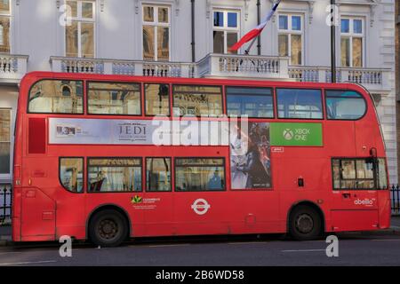 A red double decker bus is parked outside the Lycée Francais Charles de Gaulle school at 29 Cromwell Road, South Kensington, London, UK. Stock Photo