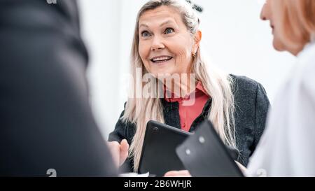close up. smiling businesswoman talking to her colleagues Stock Photo