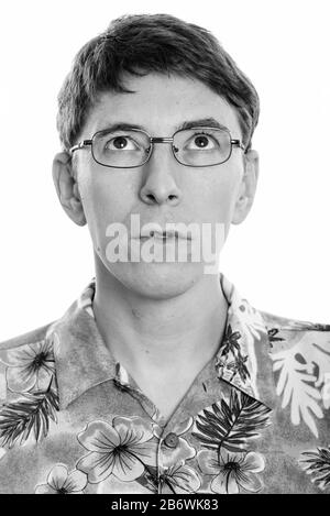 Face of man thinking while wearing Hawaiian shirt Stock Photo