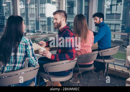 Back view of young managers having break after meeting. Stock Photo