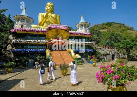 Dambulla, Sri Lanka - February 2020: People visiting Golden temple of Dambula on February 8, 2020 in Dambulla, Sri Lanka. Stock Photo