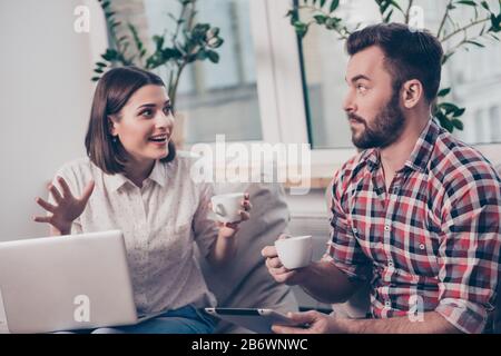 Two young managers with coffee discussing creative ideas. Stock Photo