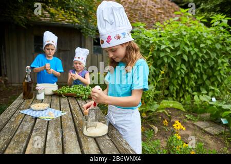 Children investigating food. Series: Making pesto, therefore grating cheese. Learning according to the Reggio Pedagogy principle, playful understanding and discovery. Germany. Stock Photo