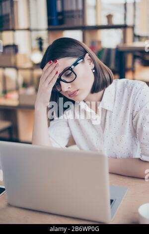 Young pretty businesswoman tired from work in the office. Stock Photo