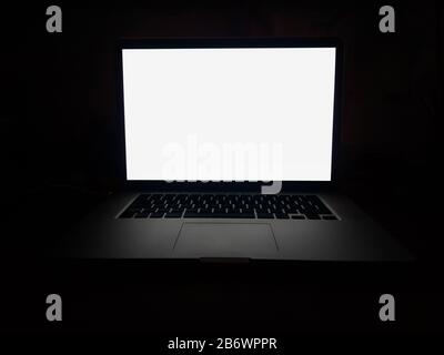 open laptop with blank screen on dark background Stock Photo