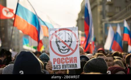 MOSCOW, RUSSIA - 29 FEBRUARY 2020, March in memory of Boris Nemtsov. Flags of Russia, people and Poster with text: "Russia without Putin" Stock Photo