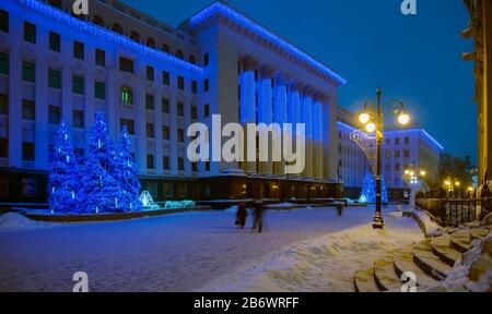Illuminated Presidential Administration building with Christmas (New Year) fir-trees. Ukraine, Kiev. Stock Photo