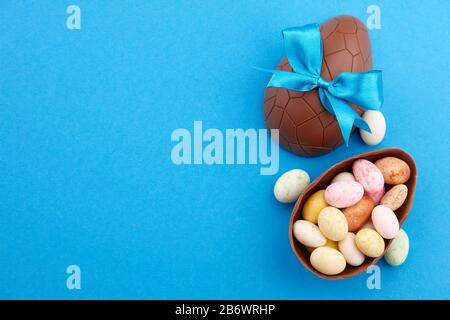 Chocolate Easter eggs with colorful candies Stock Photo