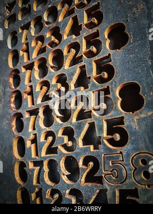 fragment of a concrete wall with embossed numbers. Stock Photo