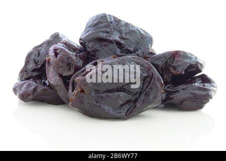 Pile of dried bio plums without stone. Isolated on white background with shadow reflection. With clipping path. With vector path. Dry organic plums on Stock Photo