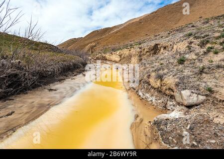 Polluted river with toxic yellow water Stock Photo