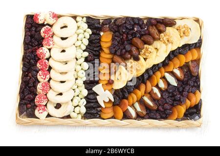 Mixture of dried fruits. Isolated on white background with natural shadow. With clipping path. With vector path. Mix of dried fruits and hazelnuts, ap Stock Photo