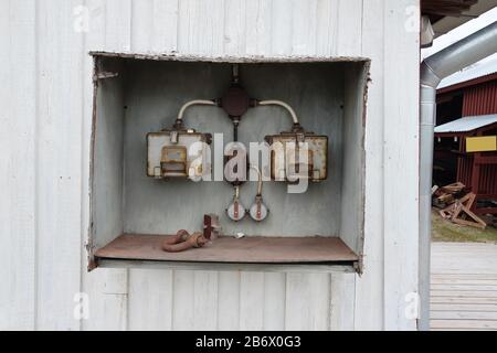 Old and rusty electric control box on the wall. Stock Photo