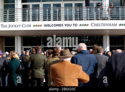 Racegoers queue up ahead of day three of the Cheltenham Festival at Cheltenham Racecourse. Stock Photo