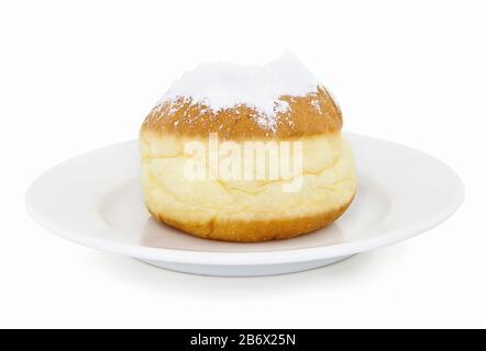 Homemade deep fried doughnut filled with jelly. In slovak: "siska". In german: "Krepfen". Sprinkled with powdered sugar. Isolated on white background. Stock Photo