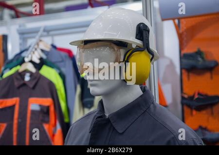Male mannequin with clothing, gloves and special protection means in the exhibition hall. Industry Stock Photo