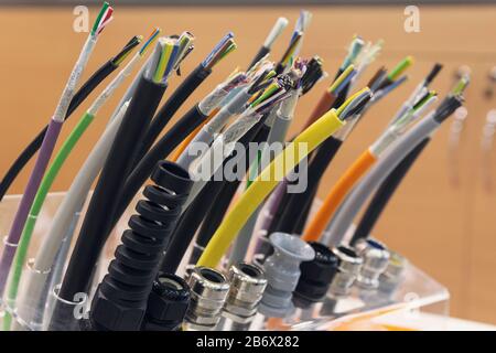 Different separation power cables on the showcase close up. Industry Stock Photo