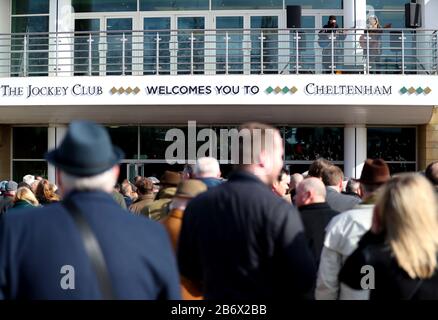 Racegoers queue up ahead of day three of the Cheltenham Festival at Cheltenham Racecourse. Stock Photo