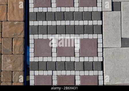 Gray stone of pavement  at construction site. Warehouse paving slabs for laying road. Construction of sidewalks. Stock Photo
