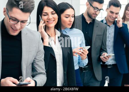 close up. a group of diverse young people are using their smartphones Stock Photo