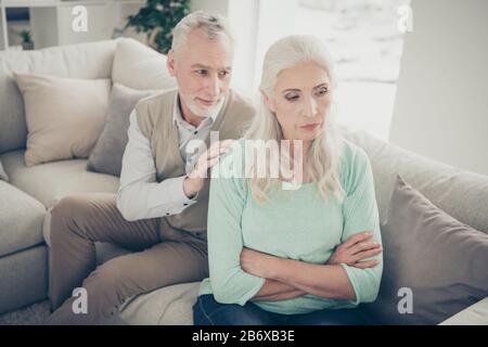 Close-up photo of careful happy smiling positive kind sincere old granddad trying to come to common ground with his beloved beautiful old lady Stock Photo
