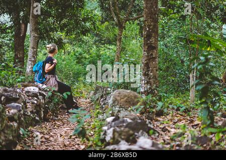 Female traveler rest during hike in coffee plantation on Santo Antao Cape Verde. Stock Photo