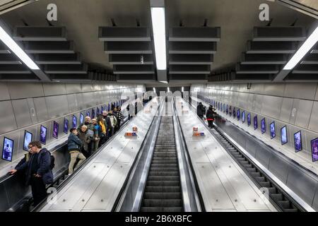 People on London underground tube station escalators, Tottenham Court Road station, London, England, UK Stock Photo