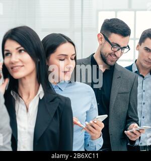 group of diverse business people using their smartphones Stock Photo