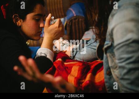 A young woman has henna applied to her hands and arm in Fes, Morocco Stock Photo