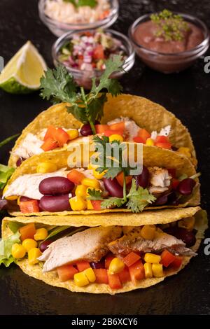 three mexican tacos on slate Stock Photo