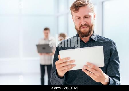 serious businessman reading message on digital tablet Stock Photo